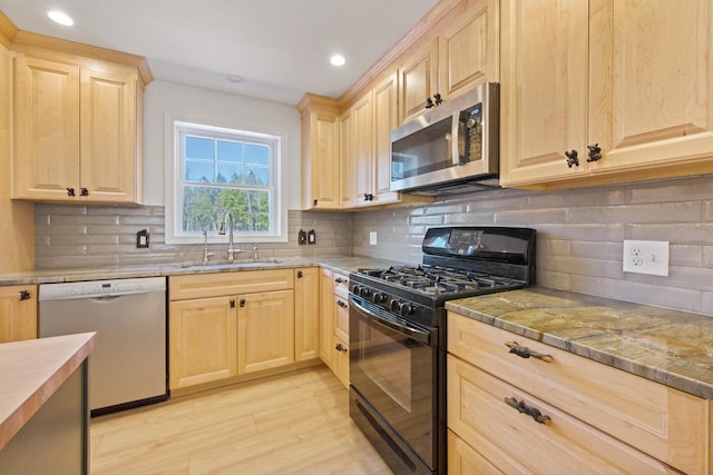 573 Exeter Rd, Corinth, ME 04427 - kitchen featuring appliances with stainless steel finishes, light brown cabinets, a sink, light wood finished floors, and recessed lighting