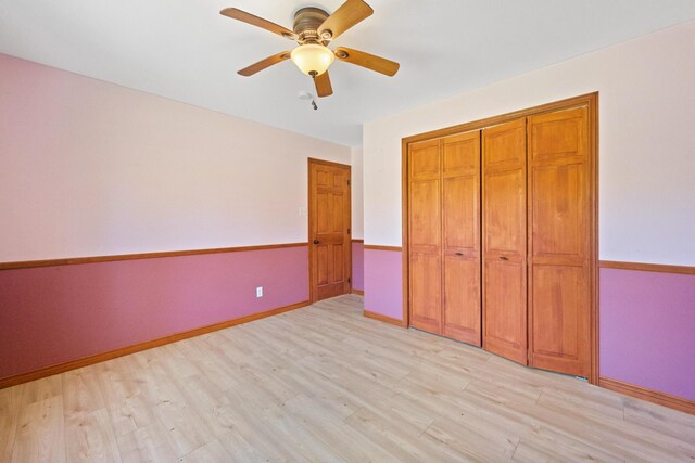 573 Exeter Rd, Corinth, ME 04427 - unfurnished bedroom with light wood-style flooring, baseboards, ceiling fan, and a closet