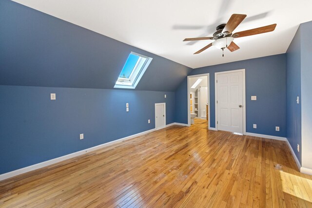 573 Exeter Rd, Corinth, ME 04427 - additional living space with a skylight, ceiling fan, light wood-style floors, baseboards, and vaulted ceiling