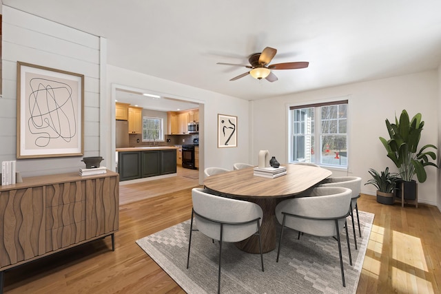 573 Exeter Rd, Corinth, ME 04427 - dining area with light wood-style flooring, a ceiling fan, plenty of natural light, and baseboards