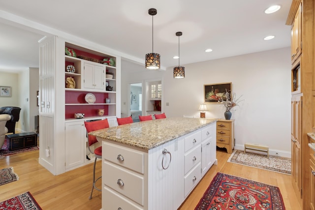 kitchen featuring a kitchen island, open shelves, white cabinets, and light wood-style floors