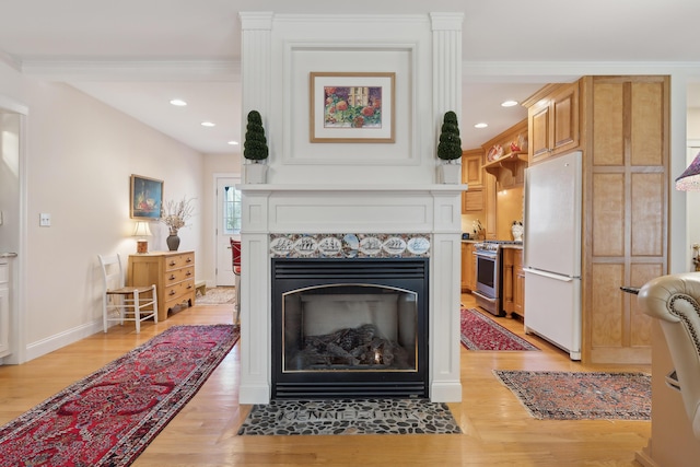 details with freestanding refrigerator, recessed lighting, stainless steel gas range oven, and wood finished floors