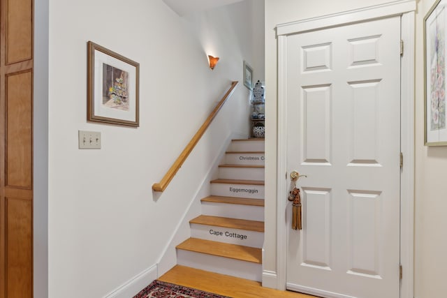 staircase featuring wood finished floors