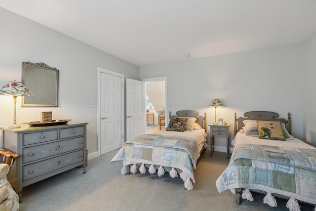 bedroom featuring baseboards and carpet