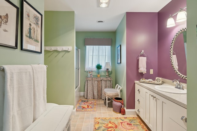 full bath with vanity, baseboards, and visible vents
