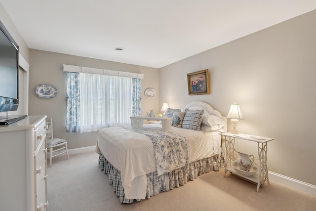 carpeted bedroom with baseboards and visible vents
