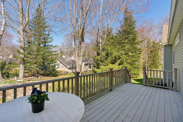 wooden terrace with outdoor dining area