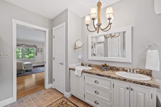 59 Beach Ave, Kennebunk, ME 04043 - ensuite bathroom with a chandelier and double vanity