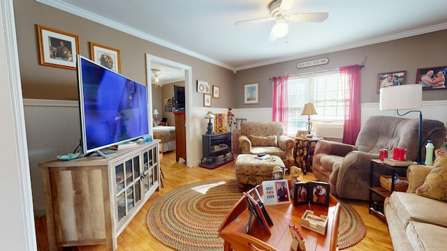 150 Enfield Rd, Lincoln, ME 04457 - living room featuring light wood-type flooring, crown molding, a wainscoted wall, and ceiling fan