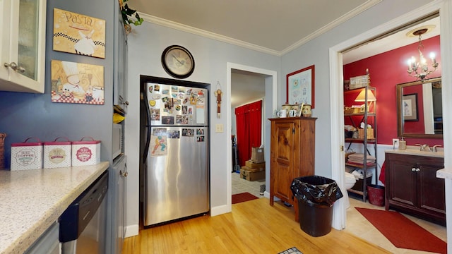 150 Enfield Rd, Lincoln, ME 04457 - kitchen featuring glass insert cabinets, light wood-type flooring, appliances with stainless steel finishes, crown molding, and light stone counters