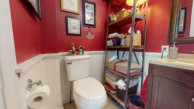 150 Enfield Rd, Lincoln, ME 04457 - bathroom featuring toilet, a wainscoted wall, and vanity