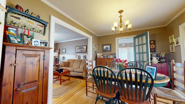 150 Enfield Rd, Lincoln, ME 04457 - dining space featuring a chandelier, light wood-style floors, and ornamental molding