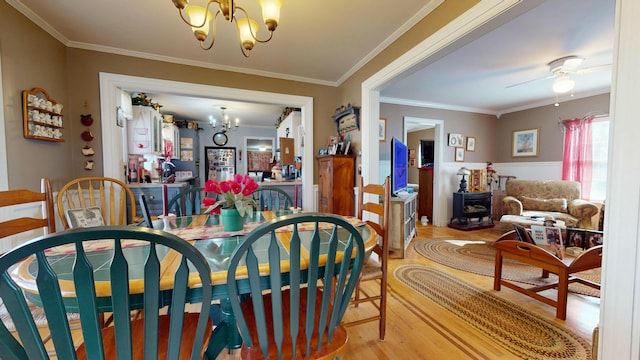 150 Enfield Rd, Lincoln, ME 04457 - dining space with an inviting chandelier, ornamental molding, and wood finished floors