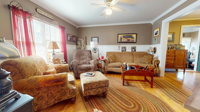 150 Enfield Rd, Lincoln, ME 04457 - living room with ornamental molding, light wood-type flooring, ceiling fan, and wainscoting