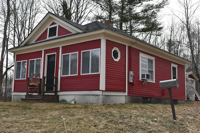 150 Enfield Rd, Lincoln, ME 04457 - view of front of house with a front yard, cooling unit, and a chimney