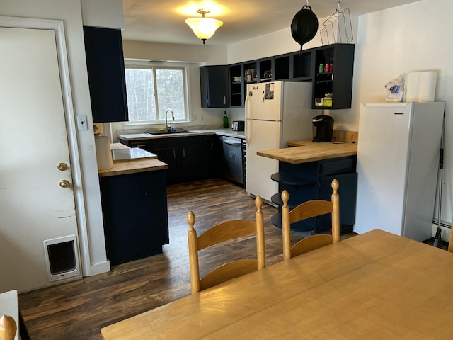 980 Dover Rd, Dexter, ME 04930 - kitchen with dark cabinets, a sink, freestanding refrigerator, and dishwasher