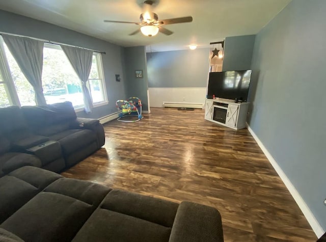 980 Dover Rd, Dexter, ME 04930 - living room with a ceiling fan, baseboards, baseboard heating, and dark wood-style floors
