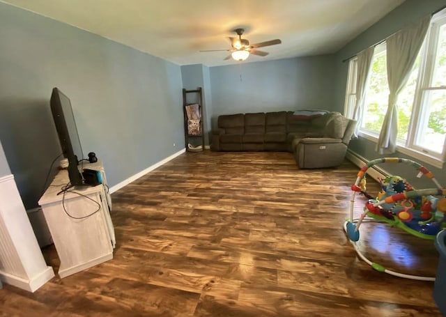 980 Dover Rd, Dexter, ME 04930 - living room featuring dark wood-type flooring, ceiling fan, and baseboards