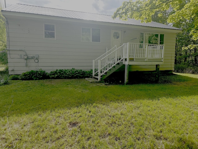980 Dover Rd, Dexter, ME 04930 - back of property featuring a lawn, metal roof, stairway, and a deck