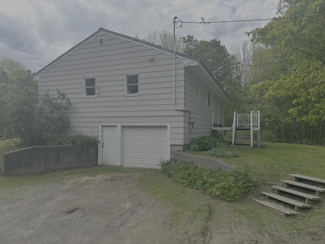 980 Dover Rd, Dexter, ME 04930 - view of side of property featuring driveway, a garage, and a lawn