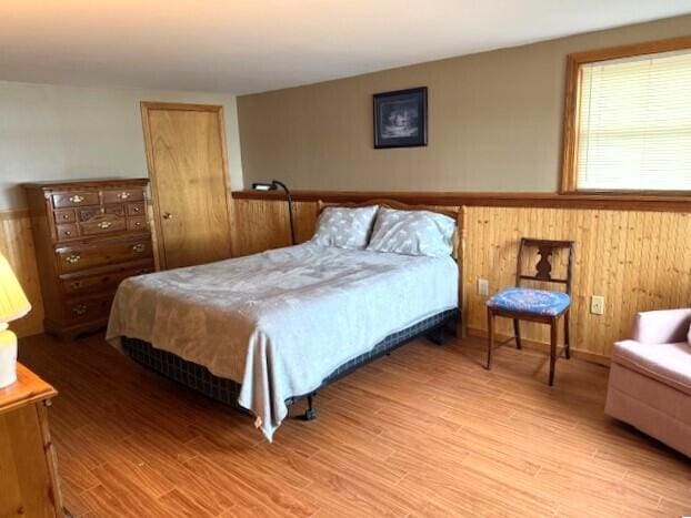 160 Pinkhams Cove Rd, Belgrade, ME 04917 - bedroom featuring wainscoting and wood finished floors