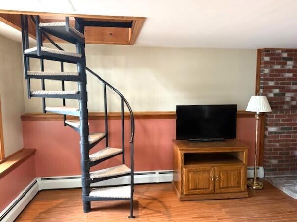 160 Pinkhams Cove Rd, Belgrade, ME 04917 - stairway with a baseboard heating unit and wood finished floors