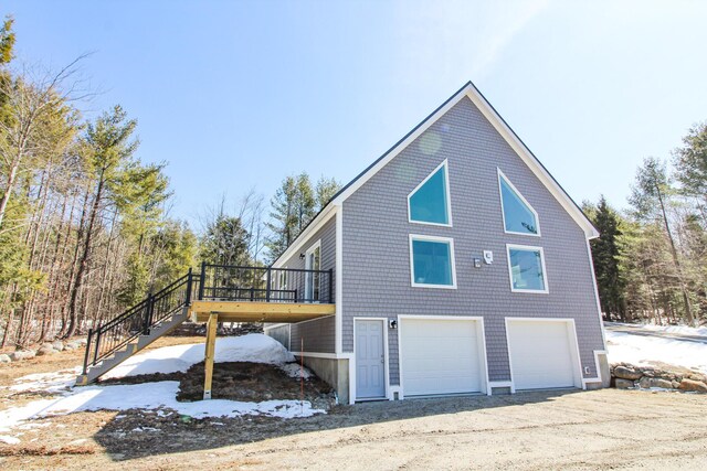 28 First St, Bethel, ME 04217 - view of home's exterior with stairway, a deck, and a garage