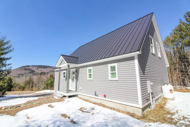 28 First St, Bethel, ME 04217 - view of front of house with a standing seam roof, metal roof, and a mountain view