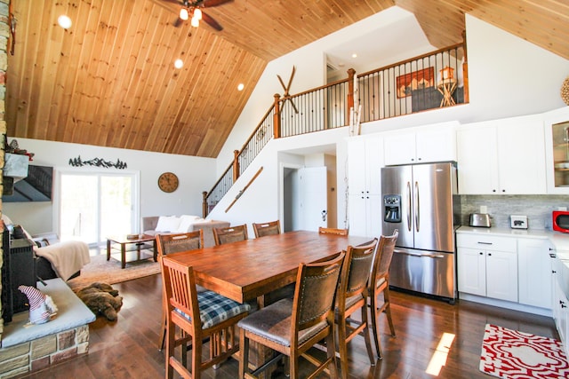 28 First St, Bethel, ME 04217 - dining room with high vaulted ceiling, wood ceiling, stairs, a ceiling fan, and dark wood-style floors