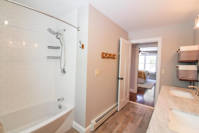 28 First St, Bethel, ME 04217 - bathroom featuring baseboard heating, bathtub / shower combination, wood finished floors, baseboards, and connected bathroom