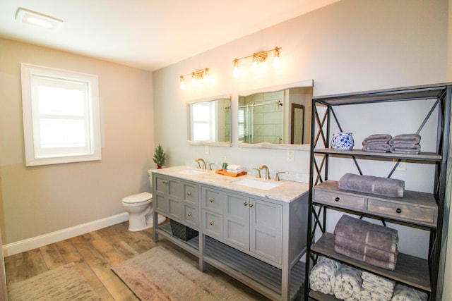 28 First St, Bethel, ME 04217 - bathroom with a stall shower, baseboards, wood finished floors, and plenty of natural light