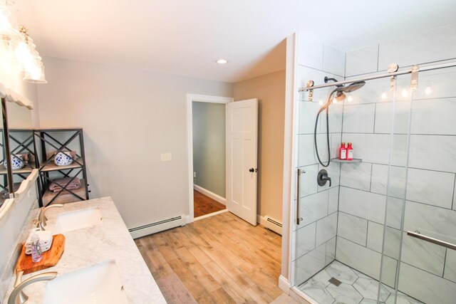 28 First St, Bethel, ME 04217 - full bath featuring a baseboard heating unit, wood finished floors, a shower stall, and recessed lighting