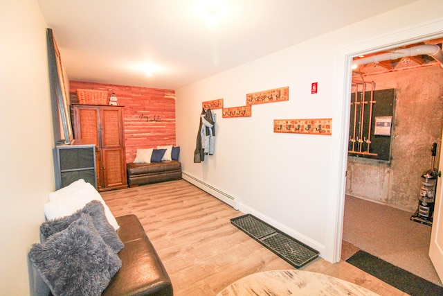 28 First St, Bethel, ME 04217 - living area featuring a baseboard heating unit and light wood finished floors