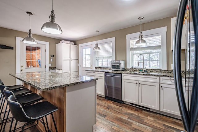 kitchen featuring a sink, white cabinetry, dishwasher, and black refrigerator