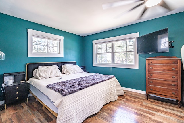 bedroom with baseboards, ceiling fan, and wood finished floors
