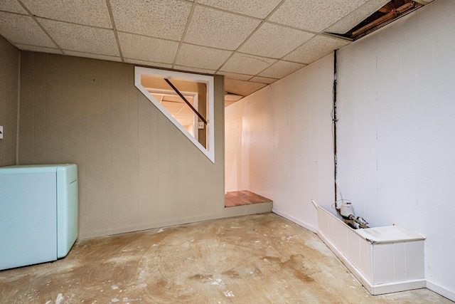 finished basement with a paneled ceiling