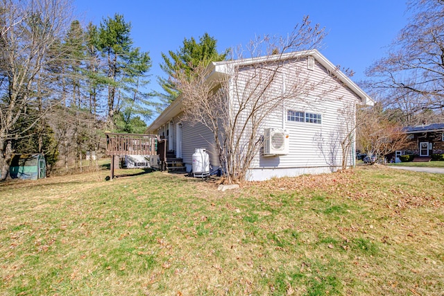 view of property exterior featuring ac unit, a yard, and a deck