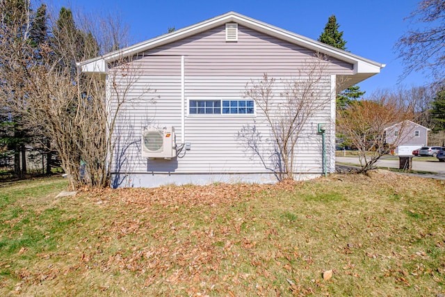 view of side of property with a lawn and ac unit