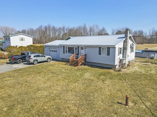 834 Main St, Bradley, ME 04411 - view of front of house with aphalt driveway, metal roof, central air condition unit, an attached garage, and a front lawn
