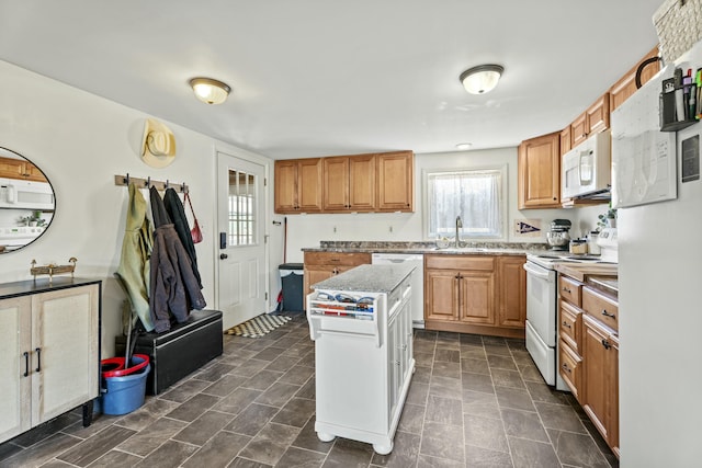 834 Main St, Bradley, ME 04411 - kitchen featuring white appliances, light stone counters, a sink, and a kitchen island