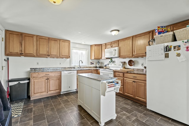 834 Main St, Bradley, ME 04411 - kitchen with white appliances, light countertops, a sink, and a kitchen island