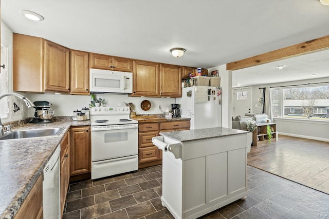 834 Main St, Bradley, ME 04411 - kitchen with a center island, white appliances, brown cabinets, and a sink