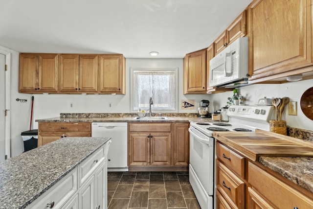 834 Main St, Bradley, ME 04411 - kitchen with white appliances, dark stone counters, a sink, stone finish flooring, and brown cabinets