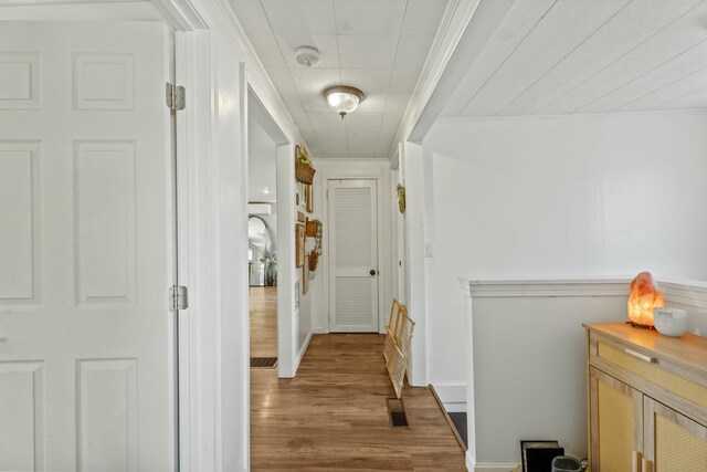 834 Main St, Bradley, ME 04411 - corridor featuring visible vents, wood finished floors, and crown molding