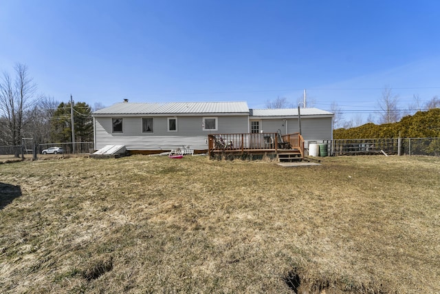 834 Main St, Bradley, ME 04411 - rear view of property with metal roof, a wooden deck, fence, and a yard