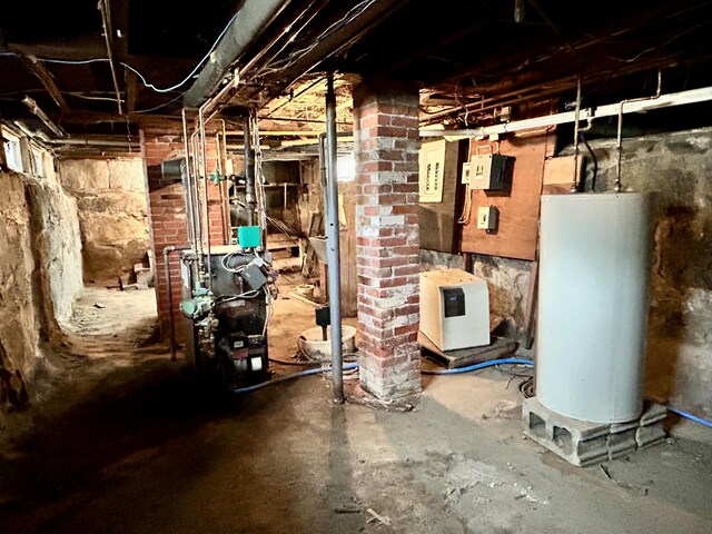 unfinished below grade area featuring a heating unit and gas water heater