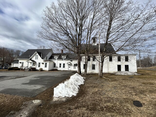 view of front of home with driveway and a chimney