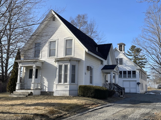 132 E Main St, Dover-Foxcroft, ME 04426 - view of front facade featuring an attached garage and driveway