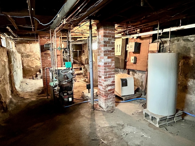 132 E Main St, Dover-Foxcroft, ME 04426 - unfinished basement featuring gas water heater and a heating unit