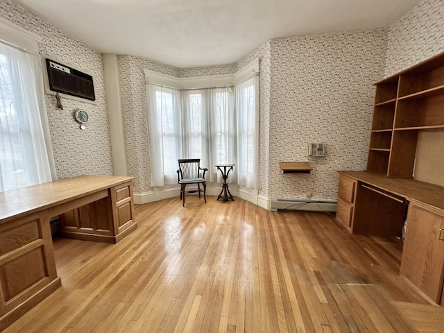 132 E Main St, Dover-Foxcroft, ME 04426 - office space featuring light wood-style floors, wallpapered walls, a baseboard heating unit, and baseboards